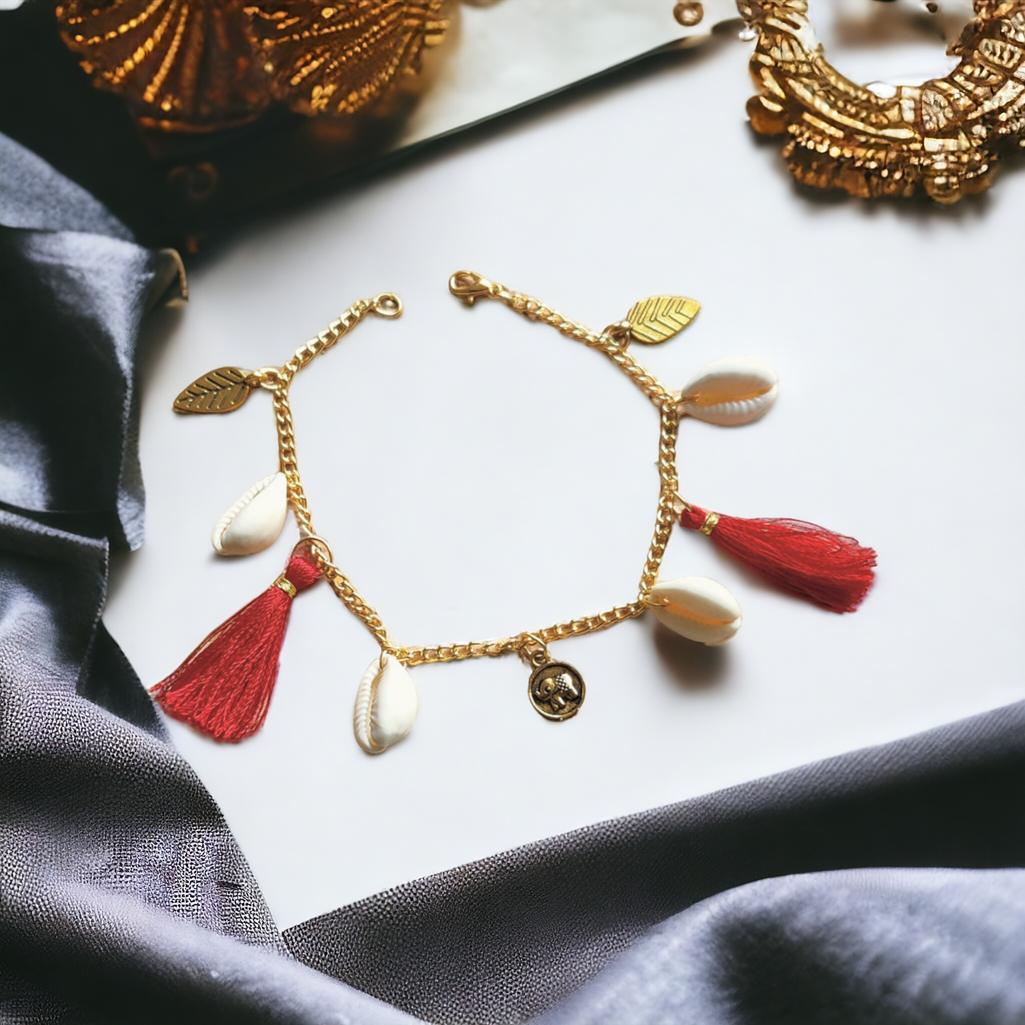 Fancy Bracelet Made Of Golden Chain, Cowrie, Silk Threads & Charms
